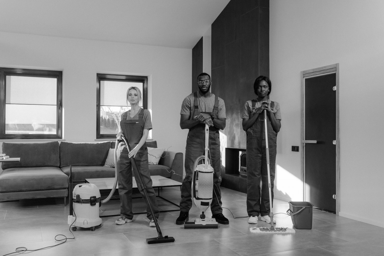 Man and woman standing while holding vacuum cleaner