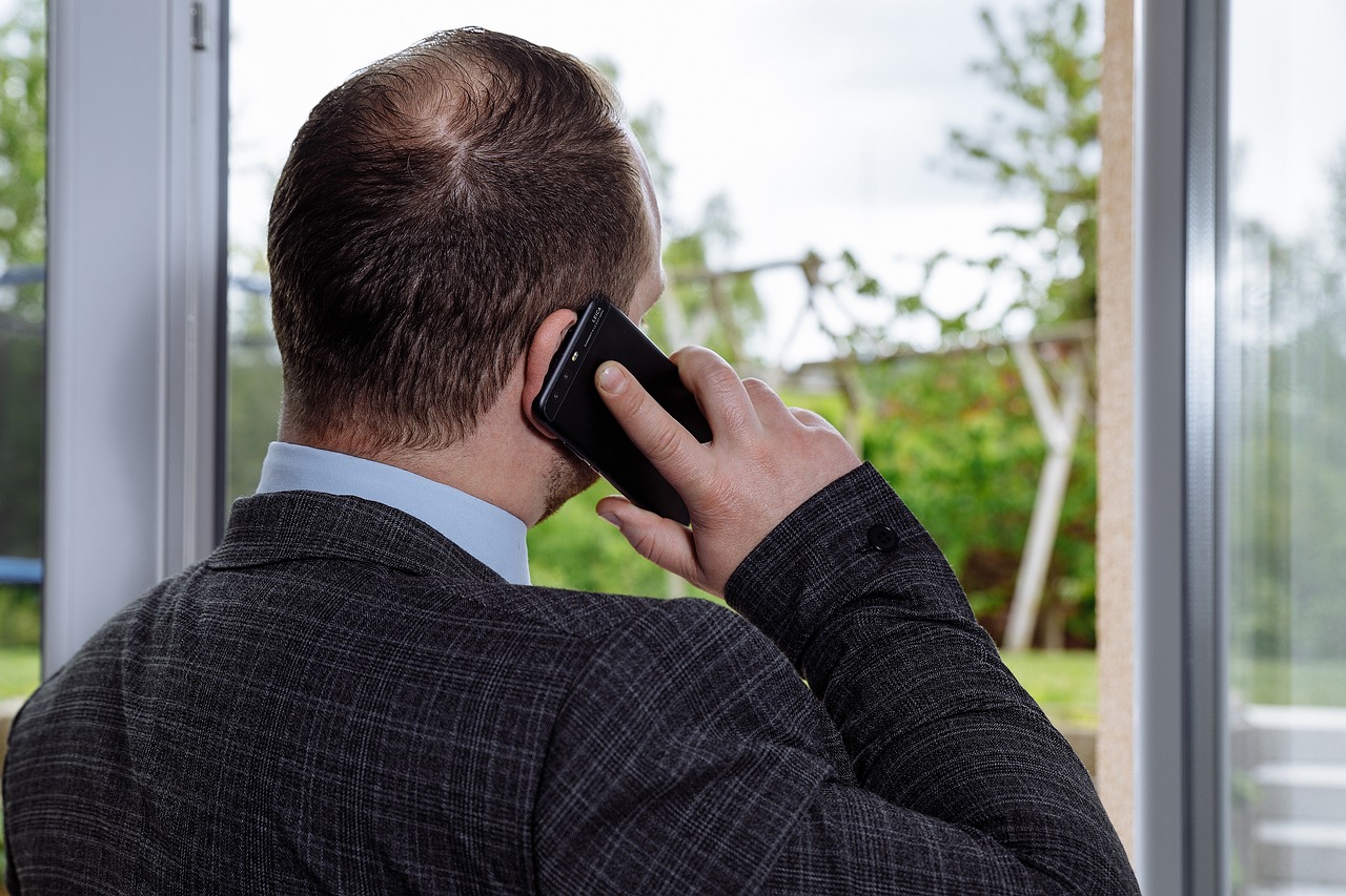 A realtor having a call session with his client about a business deal
