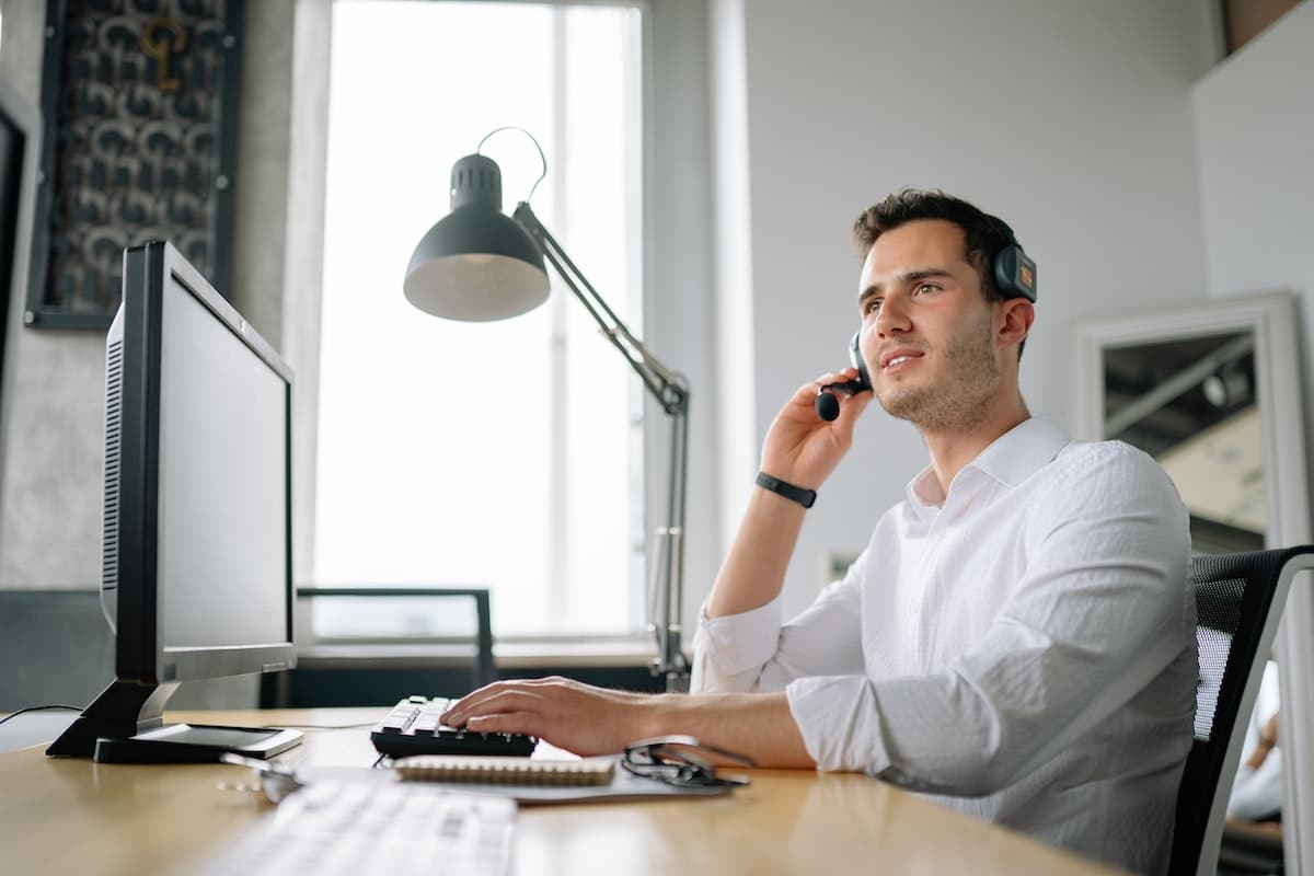 Male agent providing customer service over a call.