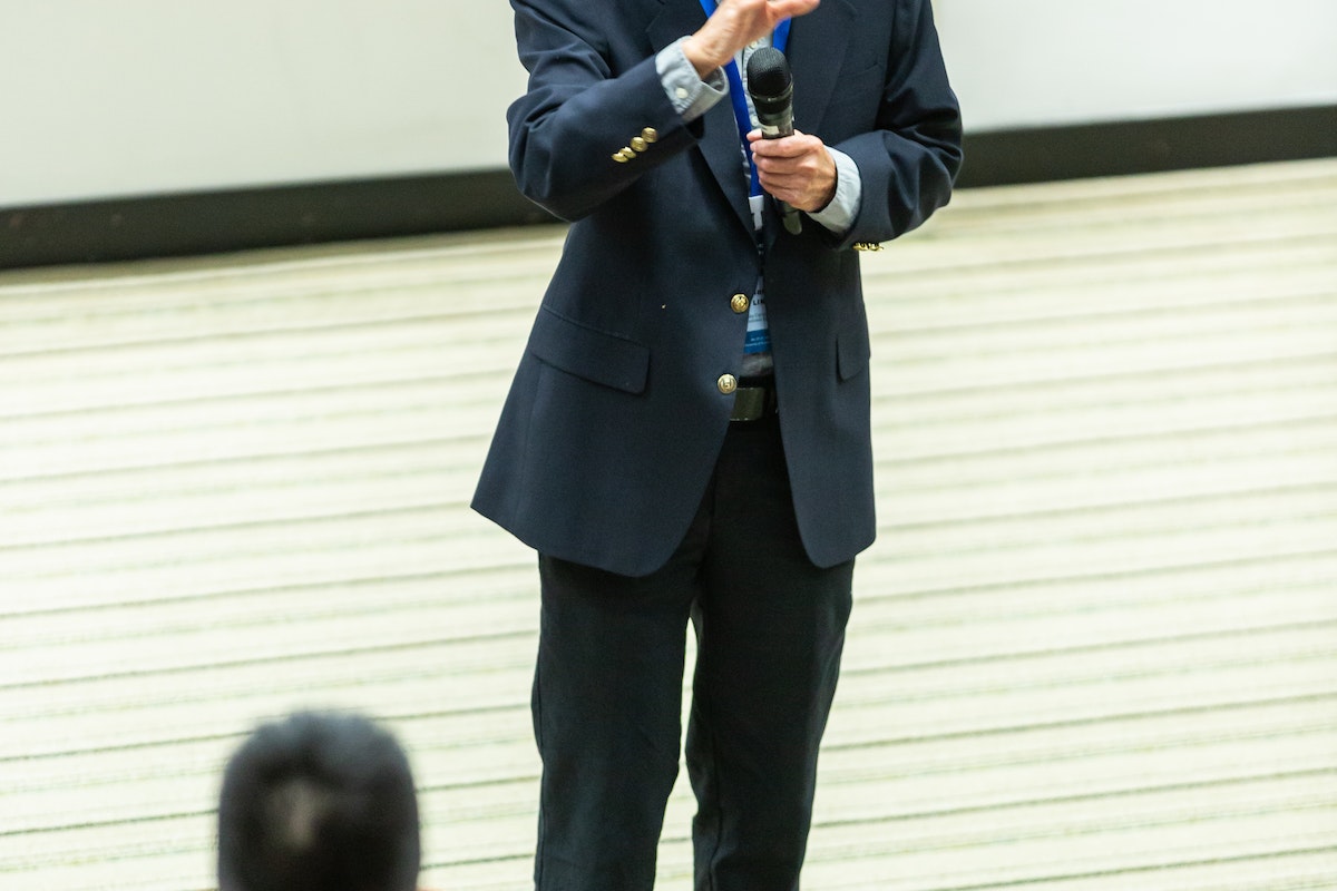 Man giving a speech about what makes great leadership.