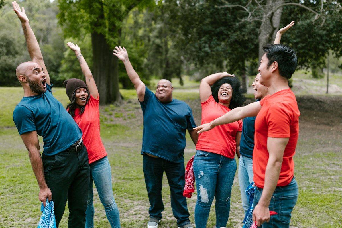 Real estate agents having fun doing casual teamwork exercises.