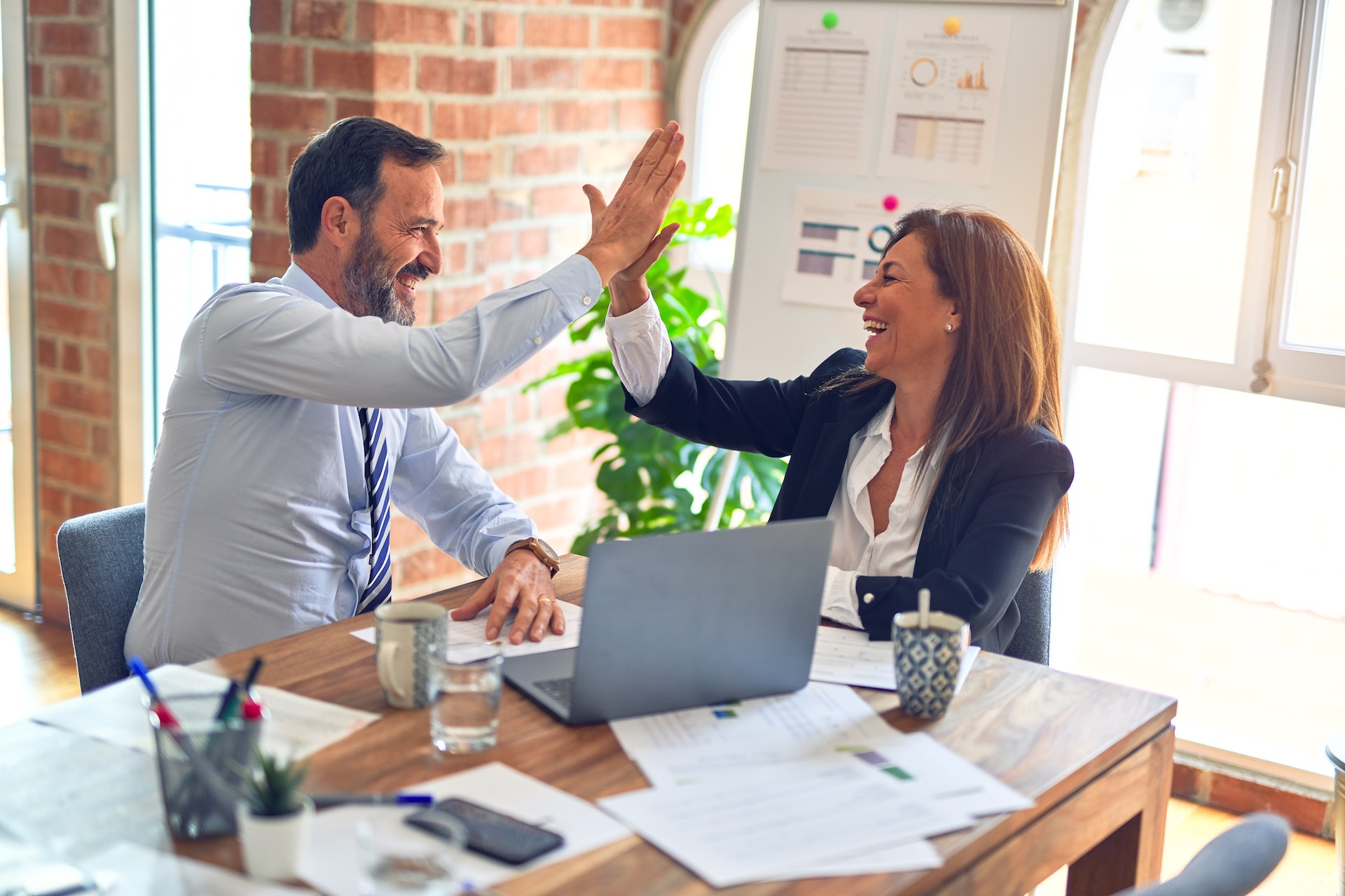 Two business people high-fiving