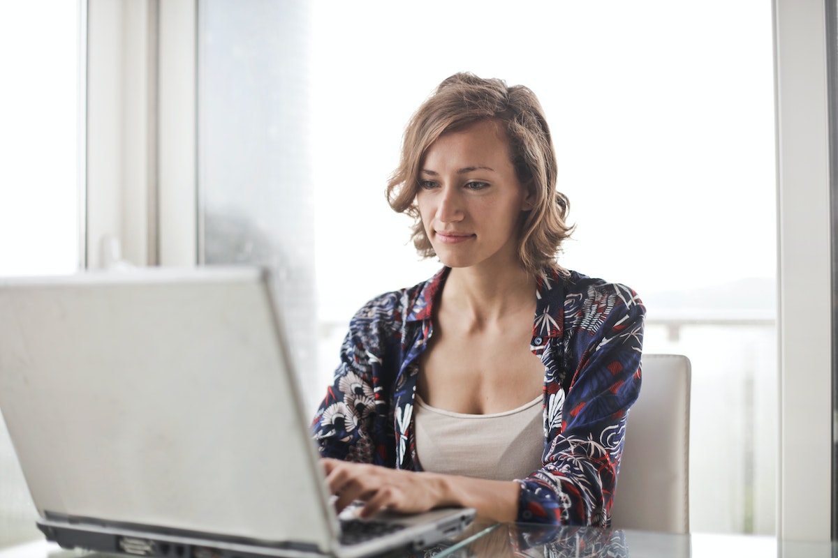 Woman looking at real estate agent Facebook description examples.