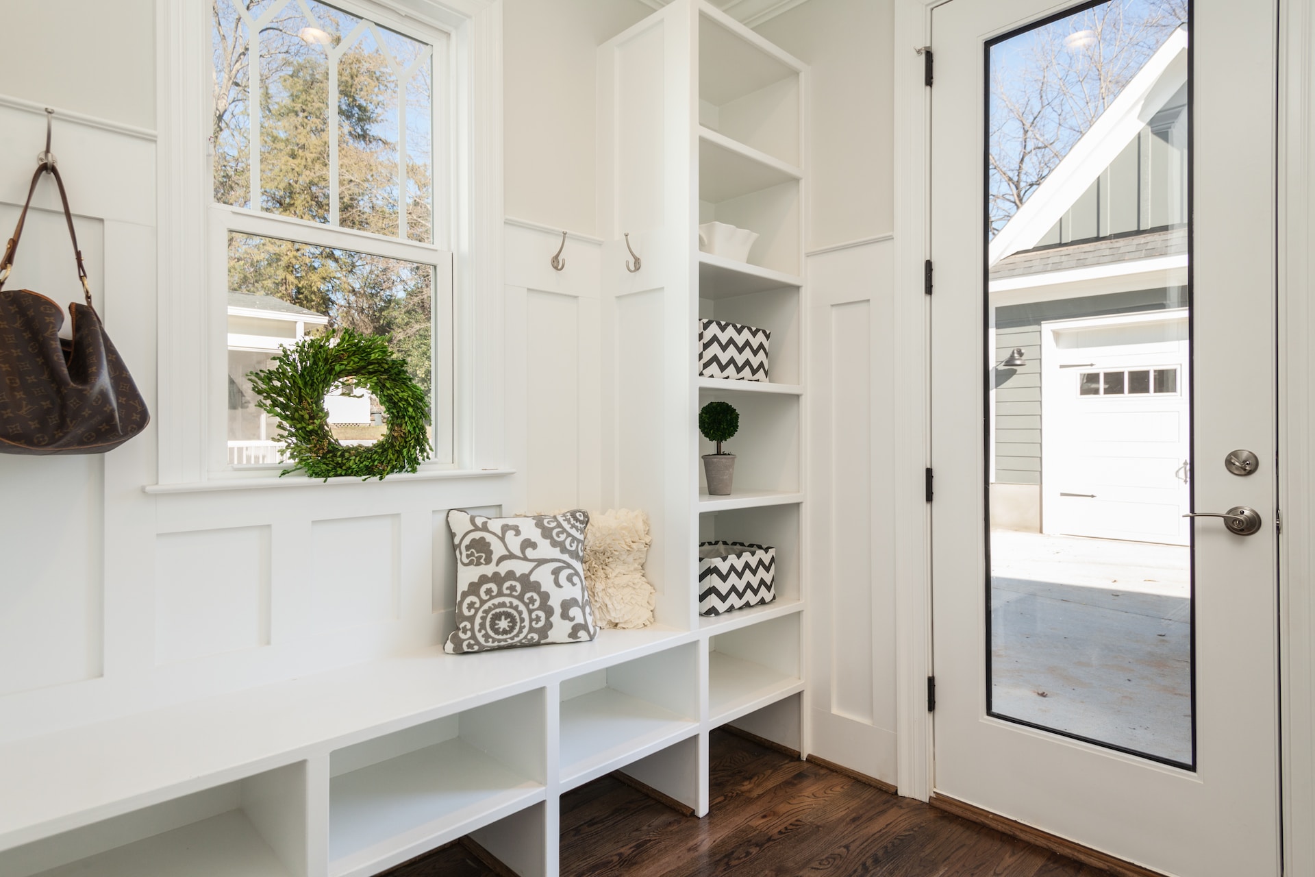 Gray and white floral throw pillow beside rack inside room