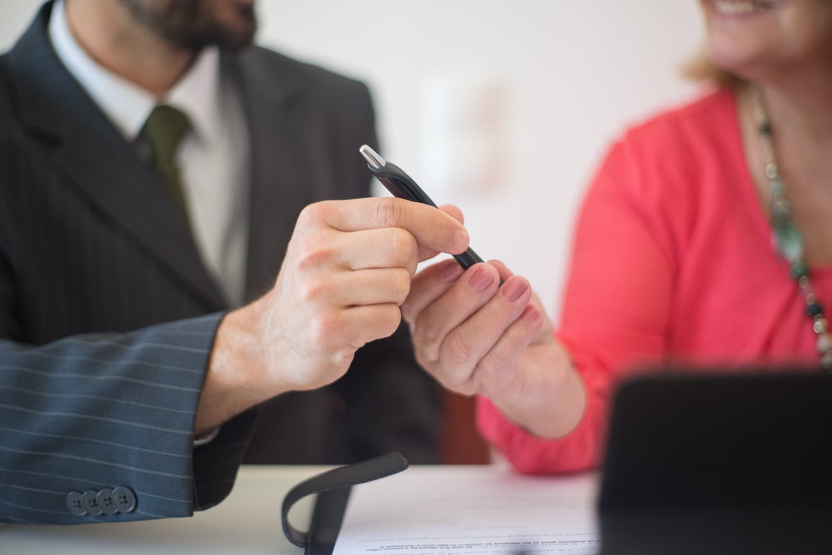 Businessman and Client Holding Pen