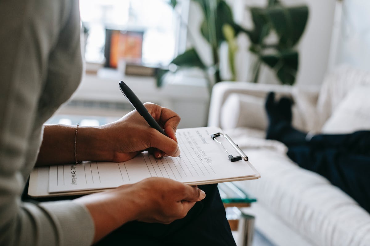 a person filling out a referral form for real estate agents